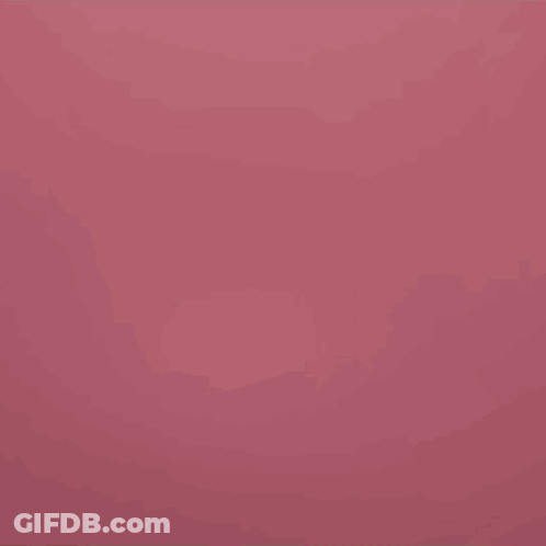 A Man In A Green And White Shirt Is Looking At The Camera GIF