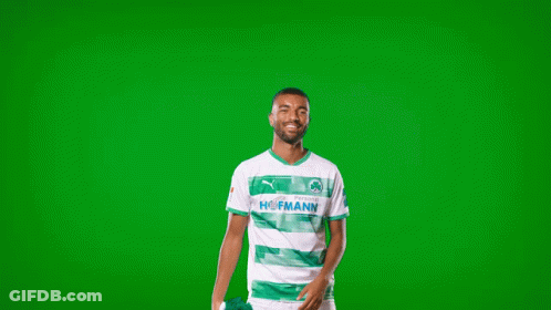 A Man In A Green And White Shirt With The Word Homann On The Front GIF