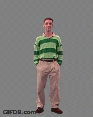 A Man In A Green And White Striped Shirt Is Standing Next To A Bunny Costume GIF