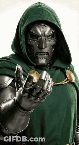 A Man In A Green Cape And Mask Holds A Coin GIF