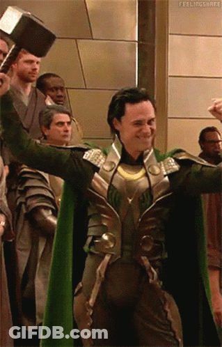A Man In A Green Cape Is Holding A Hammer In Front Of A Group Of People With The Caption Feelingshare GIF