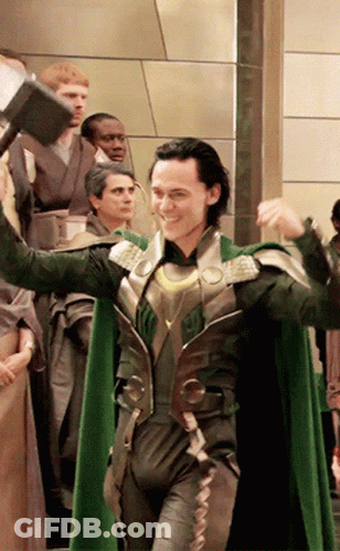A Man In A Green Cape Is Holding A Large Hammer GIF