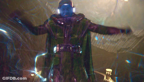 A Man In A Green Cape Is Standing In A Dark Room GIF