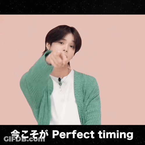 A Man In A Green Cardigan Is Pointing At The Camera With The Words Perfect Timing Written Below Him GIF