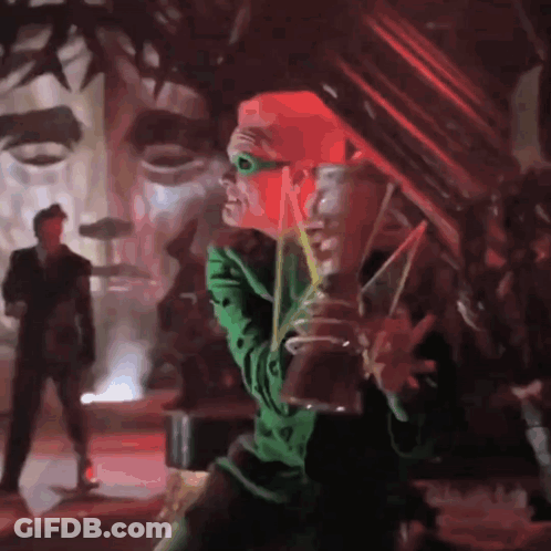 A Man In A Green Costume Is Drinking From A Glass GIF