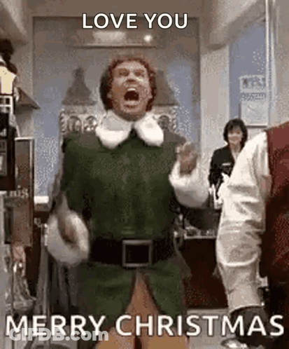 A Man In A Green Elf Costume Is Dancing In A Room And Shouting . GIF
