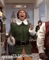 A Man In A Green Elf Costume Is Screaming With His Mouth Open In A Room . GIF