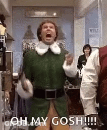 A Man In A Green Elf Costume Is Standing In A Room With His Mouth Open And Screaming . GIF