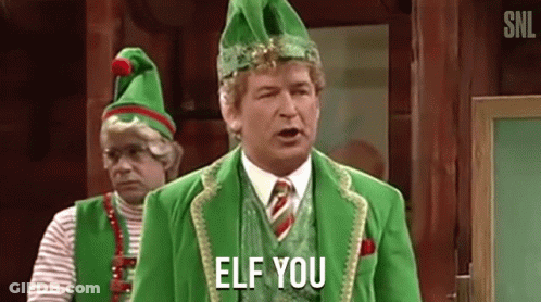 A Man In A Green Elf Costume Is Standing Next To Another Man In A Green Elf Costume . GIF