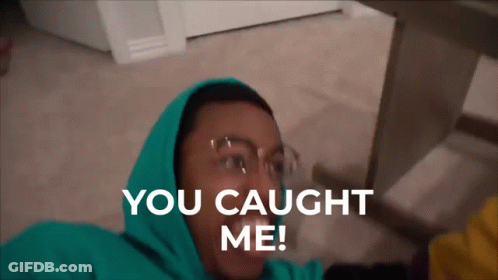 A Man In A Green Hoodie Is Laying On The Floor With The Words You Caught Me Above Him GIF