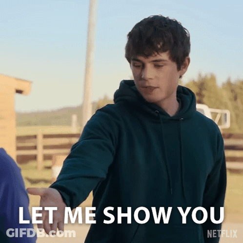 A Man In A Green Hoodie Reaches Out To Shake Someone 'S Hand And Says Let Me Show You GIF