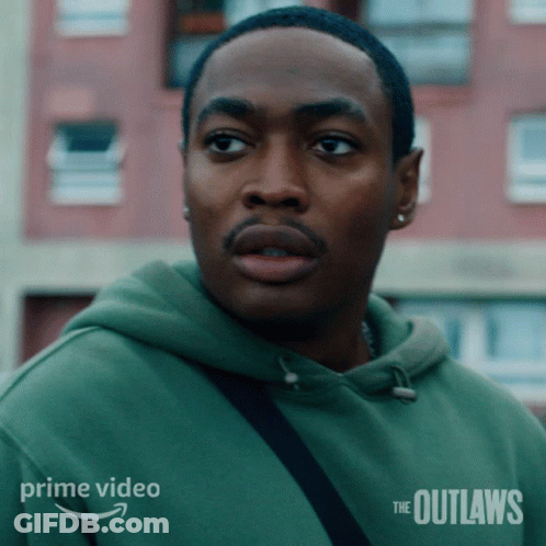 A Man In A Green Hoodie With The Outlaws On The Bottom GIF