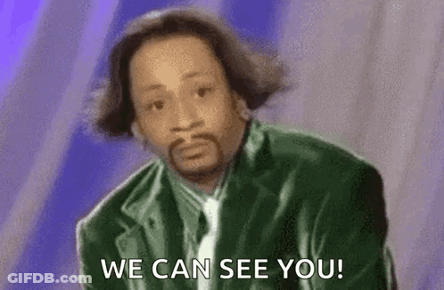 A Man In A Green Jacket And Tie Is Saying `` We Can See You '' . GIF