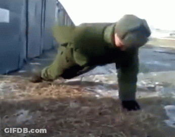 A Man In A Green Jacket Is Doing Push Ups In The Dirt GIF