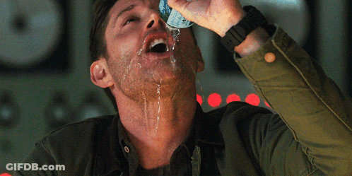 A Man In A Green Jacket Is Drinking From A Can Of Soda GIF