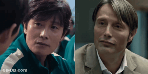A Man In A Green Jacket Is Next To A Man In A Suit GIF