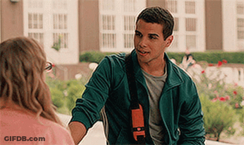 A Man In A Green Jacket Is Shaking A Woman 'S Hand . GIF