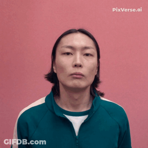 A Man In A Green Jacket Is Smiling In Front Of A Pink Background With Pixverse.ai Written On It GIF