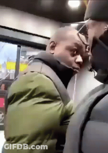 A Man In A Green Jacket Is Standing Next To Another Man In A Black Jacket . GIF
