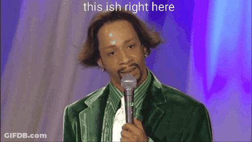 A Man In A Green Jacket Is Standing On A Stage With A Microphone And The Words This Ish Right Here Above Him GIF