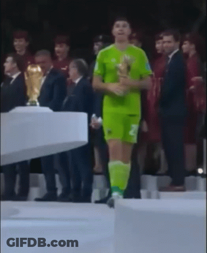 A Man In A Green Jersey With The Number 2 On It Is Holding A Trophy GIF