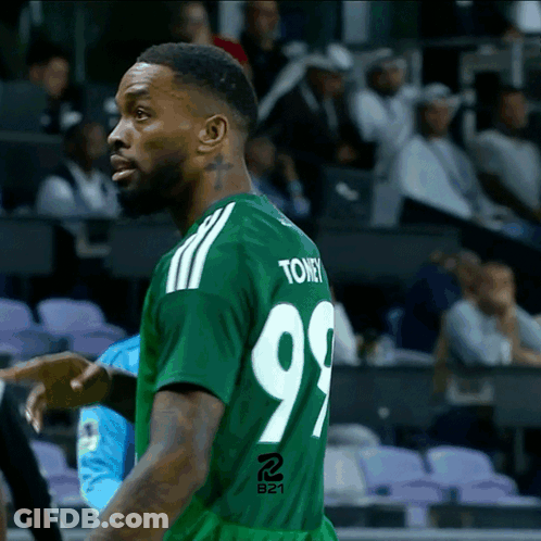 A Man In A Green Jersey With The Number 99 On The Back GIF