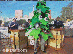 A Man In A Green Leafy Costume Stands In Front Of A Home Depot Sign GIF