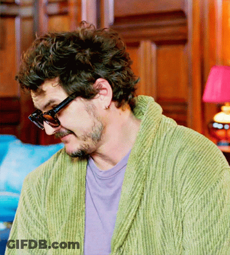 A Man In A Green Robe And Sunglasses Looks Down GIF
