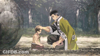 A Man In A Green Robe Is Petting A Child 'S Head While Kneeling Down In The Dirt . GIF