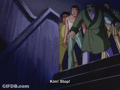 A Man In A Green Robe Is Walking Down Stairs With The Words Kim Stop Behind Him GIF