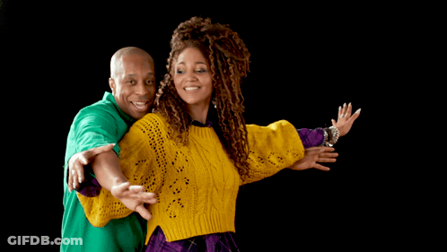 A Man In A Green Shirt And A Woman In A Yellow Sweater Are Posing For A Picture GIF