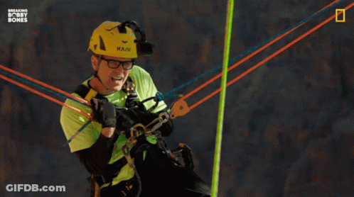 A Man In A Green Shirt And A Yellow Helmet Says " I 'M Just Holdin ' On, Man " GIF