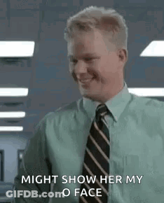 A Man In A Green Shirt And Tie Is Smiling And Saying `` Might Show Her My Face '' . GIF