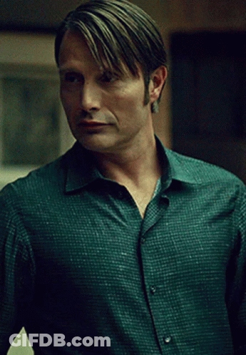 A Man In A Green Shirt Has A Very Serious Look On His Face GIF