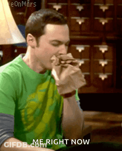A Man In A Green Shirt Is Eating A Sandwich And Says " Me Right Now " GIF