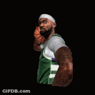 A Man In A Green Shirt Is Holding A Basketball In His Right Hand GIF