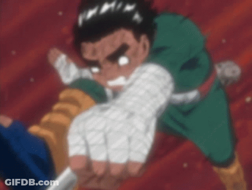 A Man In A Green Shirt Is Holding A Knife In His Right Hand . GIF