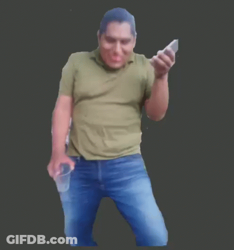 A Man In A Green Shirt Is Holding Two Cell Phones GIF