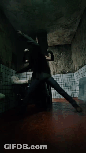 A Man In A Green Shirt Is Laying On The Floor GIF