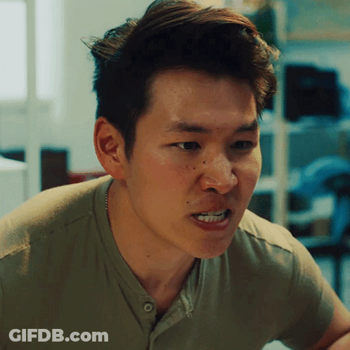 A Man In A Green Shirt Is Making A Face GIF