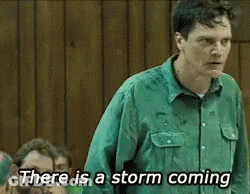 A Man In A Green Shirt Is Saying There Is A Storm Coming . GIF