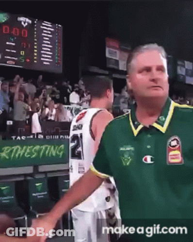 A Man In A Green Shirt Is Shaking Hands With A Basketball Player Wearing A Number 2 Jersey GIF