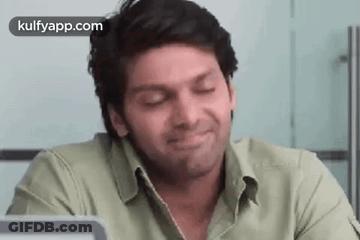 Man Smiling With Eyes Closed In Front Of Laptop GIF