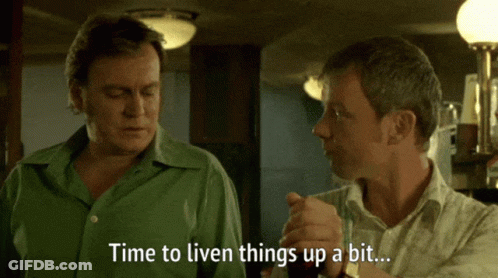 A Man In A Green Shirt Says " Time To Liven Things Up A Bit " To Another Man GIF