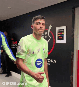 A Man In A Green Shirt Stands In Front Of A Wall That Has The Word Copa On It GIF