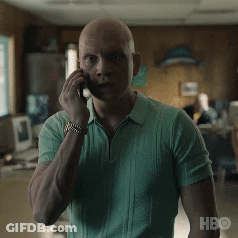 A Man In A Green Shirt Talking On A Cell Phone With Hbo Written On The Bottom GIF