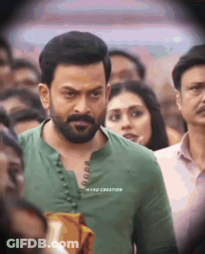 A Man In A Green Shirt With Manu Creation Written On The Front GIF