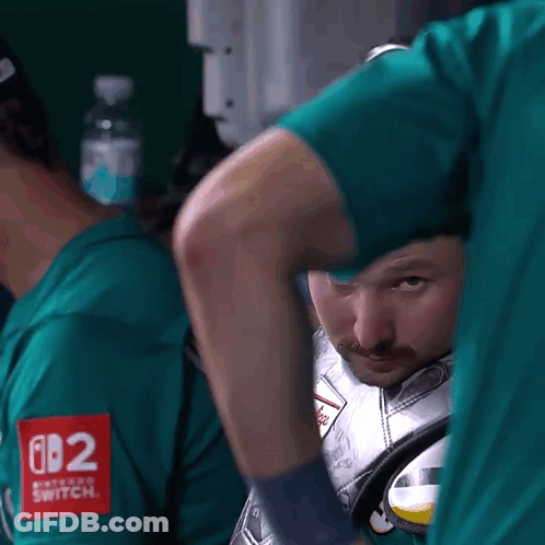 A Man In A Green Shirt With The Number 082 On The Sleeve GIF