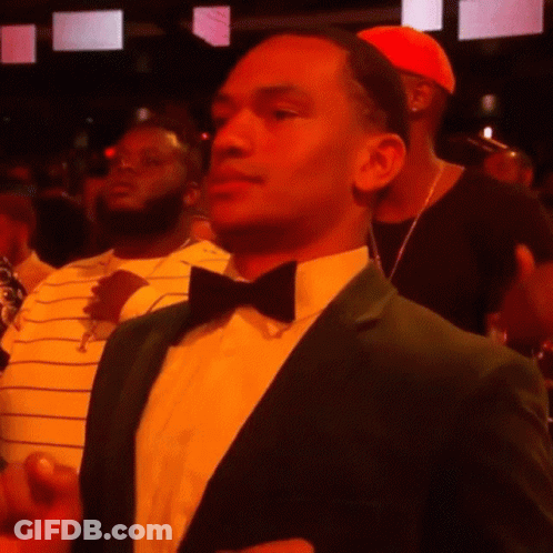 A Man In A Green Suit And Bow Tie GIF