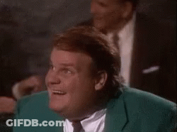 A Man In A Green Suit And Tie Is Smiling While Sitting At A Table . GIF